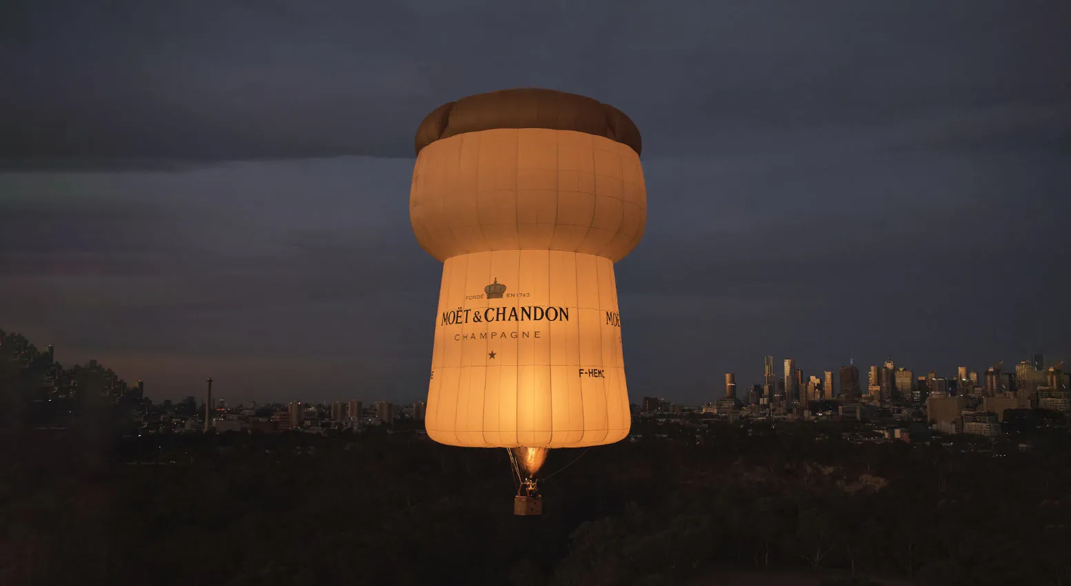 Moët & Chandon champagne-cork balloon above the city skyline
